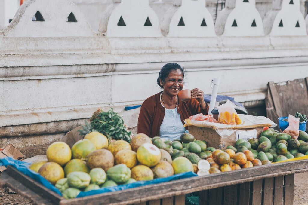 Female Fruit Seller Near A Temple