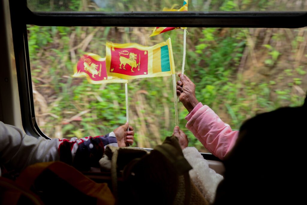 People hold national flag out of the window